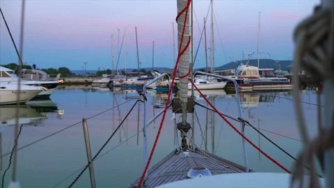 Evening harbour with yachts. View from sailboat front deck Stock Footage