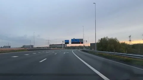 Evening highway driving with relaxed driver's perspective featuring road signs Video stock 342756167