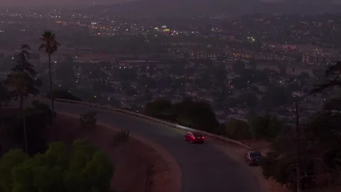 Evening Joy-Ride. Driving along city skyline. Car headlights shine towards city Stock Footage 324958156