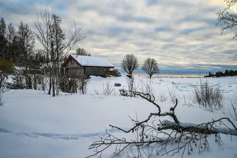 An evening landscape of cloud covered sky and snow covered lake in northern E Stock Photos