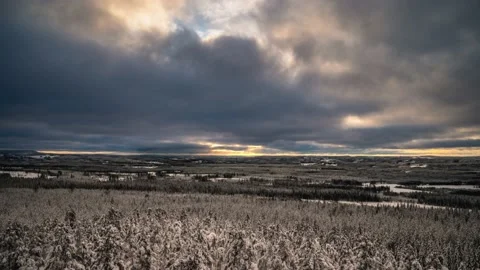 An evening landscape of cloud movement in the sky and snow covered forest in nor Video stock 149687088