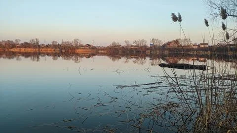 Evening landscape on the river with reflection in the water. The colorful c.. Stock Photos