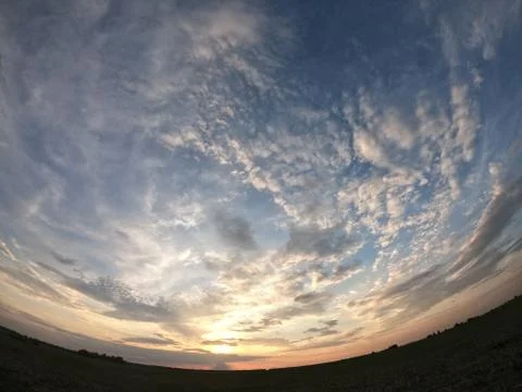 Evening landscape shot with the effect of a fish eye. Dramatic sky. 스톡 일러스트