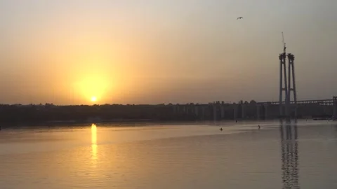 Evening landscape sunset over the river overlooking the bridges and the lonely Stock Footage 138575771