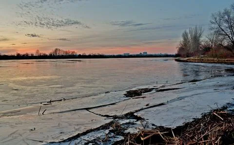 Evening on a large river covered in ice. Stock Photos