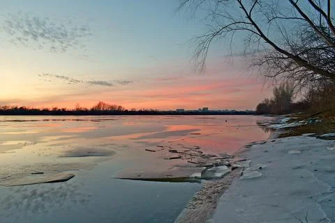 Evening on a large river covered in ice. 스톡 사진