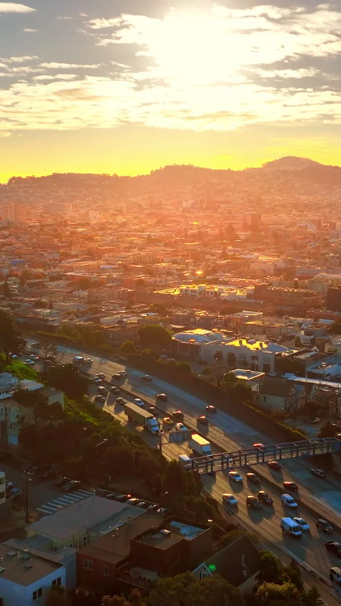 Evening light on freeway traffic and city neighborhoods, San Francisco Vertical Stock Footage 347397434