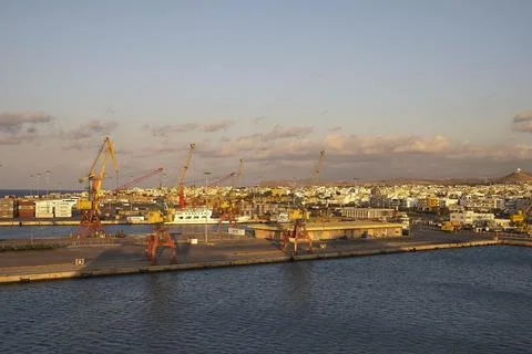 Evening light loading cranes harbour blue sky white grey clouds Heraklion Stock Photos