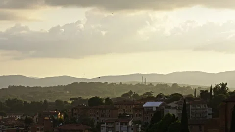 Evening Light Over Hills and Town with Birds in Flight Vidéo 256167032