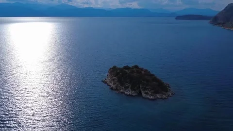 Evening light over tiny Greek island in blue sea Video stock 312738843