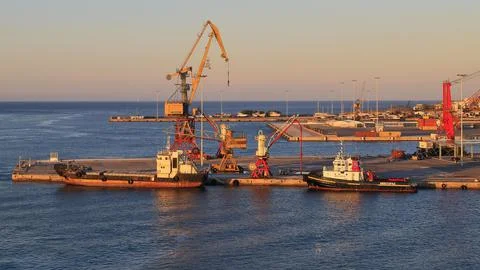 Evening light pier loading cranes tugboats port Heraklion capital island of Stock Photos