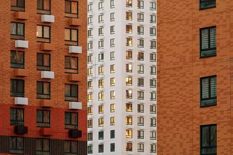 Evening light reflects in windows of high-rise buildings, forming a rhythmic Stock Photos