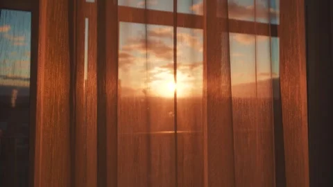 Evening light shines softly through thin fabric covering window Stock-Footage 327127127