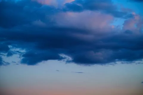 Evening light in the sky, blue clouds with evening sunlight against the dark  Stock Photos