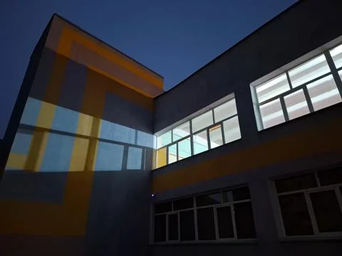 Evening light softly illuminates school gym, blending with the artificial l.. Stock Photos