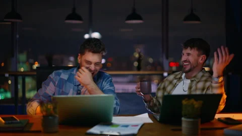 Evening managers having fun in coworking space closeup. Two auditors laughing Stock Footage 339300123