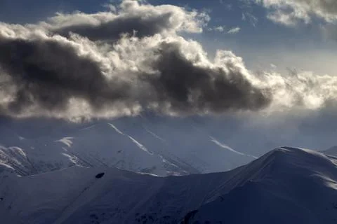Evening mountain and sunlight clouds Stock Photos