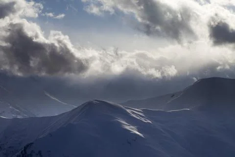Evening mountain and sunlight clouds Stock Photos