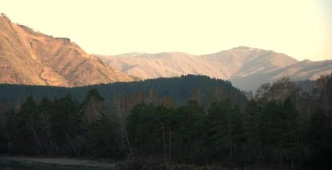Evening in the mountains, the last rays of the setting sun illuminate the mou Stock Photos