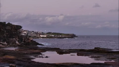 Evening to night time lapse rock pool and Sydney cliff top homes 4K Stock Footage 273270662