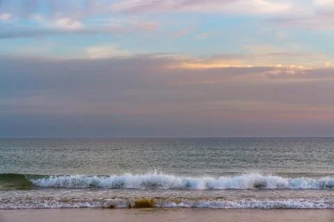 Evening ocean scene with soft waves and a serene horizon. Stock Photos