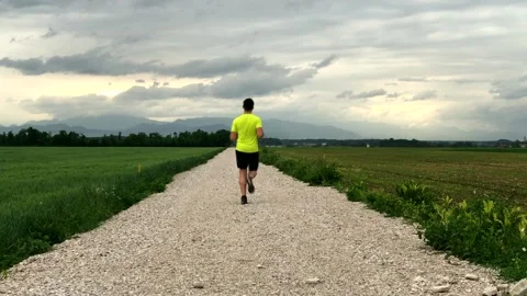 Evening one guy jogging in countryside Stock Footage 130592318