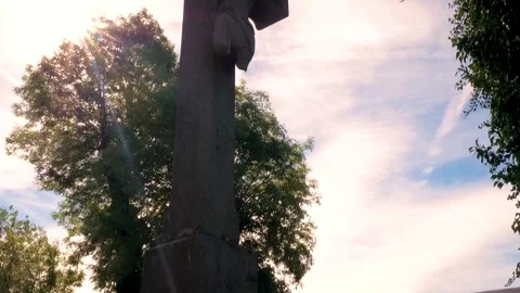 Evening or Morning Light Over Crucifix in Cemetary - Cinematic Filler Shot Stock Footage 325351378