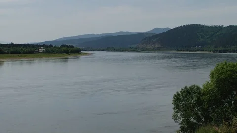 A evening over the river, waves splashing, in the distance the forest blackens. Stock Footage 107012360