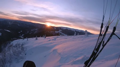 Evening Paragliding flight in winter mountains nature at beautiful sunset colors Stock Footage 148268367