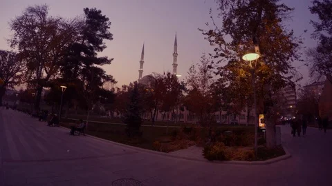 Evening park and a mosque with minarets, the silhouette of a motorcyclist rides Stock Footage 82293986