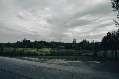 An evening park under a cloudy sky Stock Photos