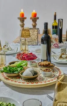 Evening Passover table lit with candles, showcasing traditional seder foods Stock Photos