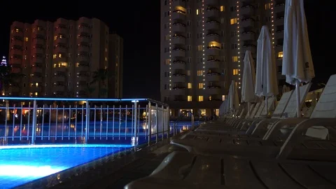 Evening, the pool area at the hotel or a multi-storey residential residence.  Video stock 95472400