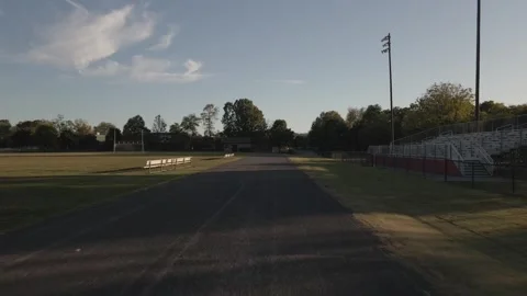 Evening practice at the local high school track Stock Footage 311944087
