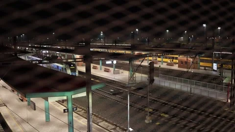 Evening railway station with passenger train at platform preparing for departure Stock Footage 323265880