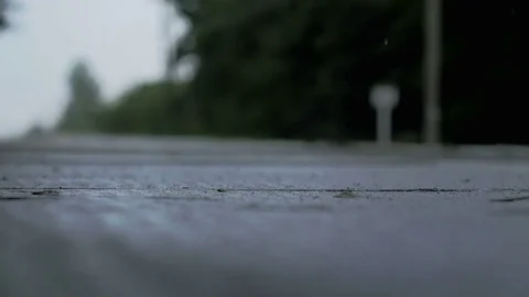 Evening rain drips onto the concrete surface Stock Footage 78064214