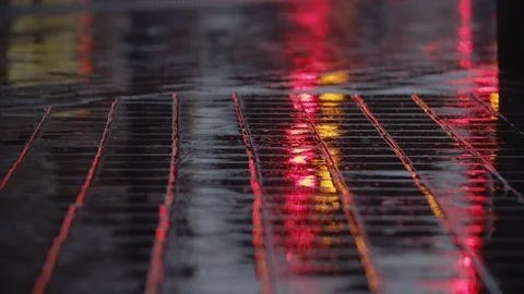 Evening rain, road lights reflecting on wet sidewalk Stock Footage 124622948