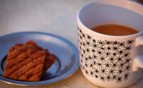 Evening refreshment with tea and biscuits Stock Photos