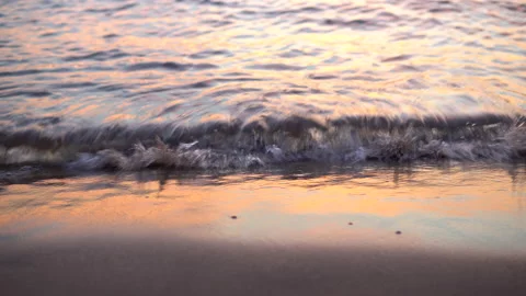 Evening relaxation on the beach. Beautiful waves at sunset, wet sand Stock Footage 135468651