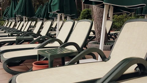 The evening at the resort. Empty sun lounger by the pool. Stock Footage 100891834