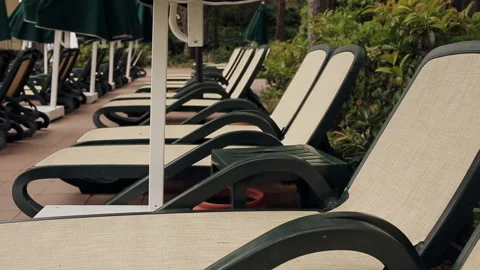 The evening at the resort. Empty sun lounger by the pool. Stock Footage 100891988