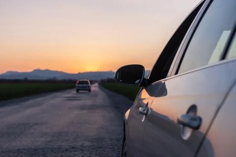 Evening road heading to sunset view from car Stock Photos