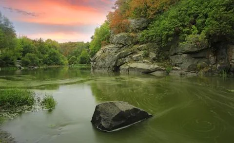 Evening on rocks over river Stock Photos