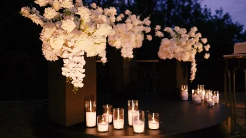 An evening romantic wedding arch of white roses for the bride and groom Stock Footage 321395886