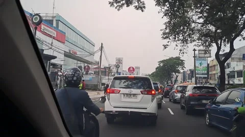 Evening rush hour traffic jalan margonda Depok West Java Indonesia Stock Footage 341931097