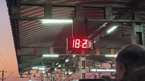 Evening Rush at Railway Platform with Digital Clock in India Stock Footage 323864946