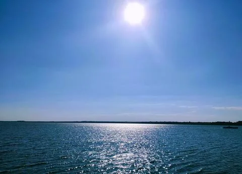 Evening by the sea with bright rays of the sun Stock Photos