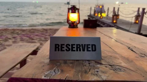 Evening sea ocean lamp reserved table at a beachside cafe. Panorama of the city Stock Footage 317808909