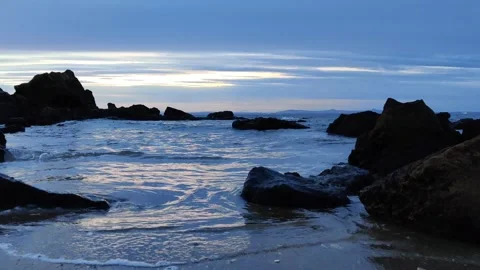 Evening seashore panorama with waves, beach and rocks Stock Footage