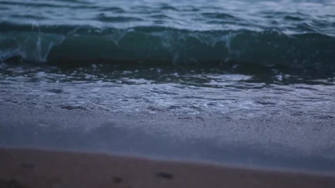 Evening seashore with wave close up. Calm night ocean water waves splashing Stock Footage 276611846